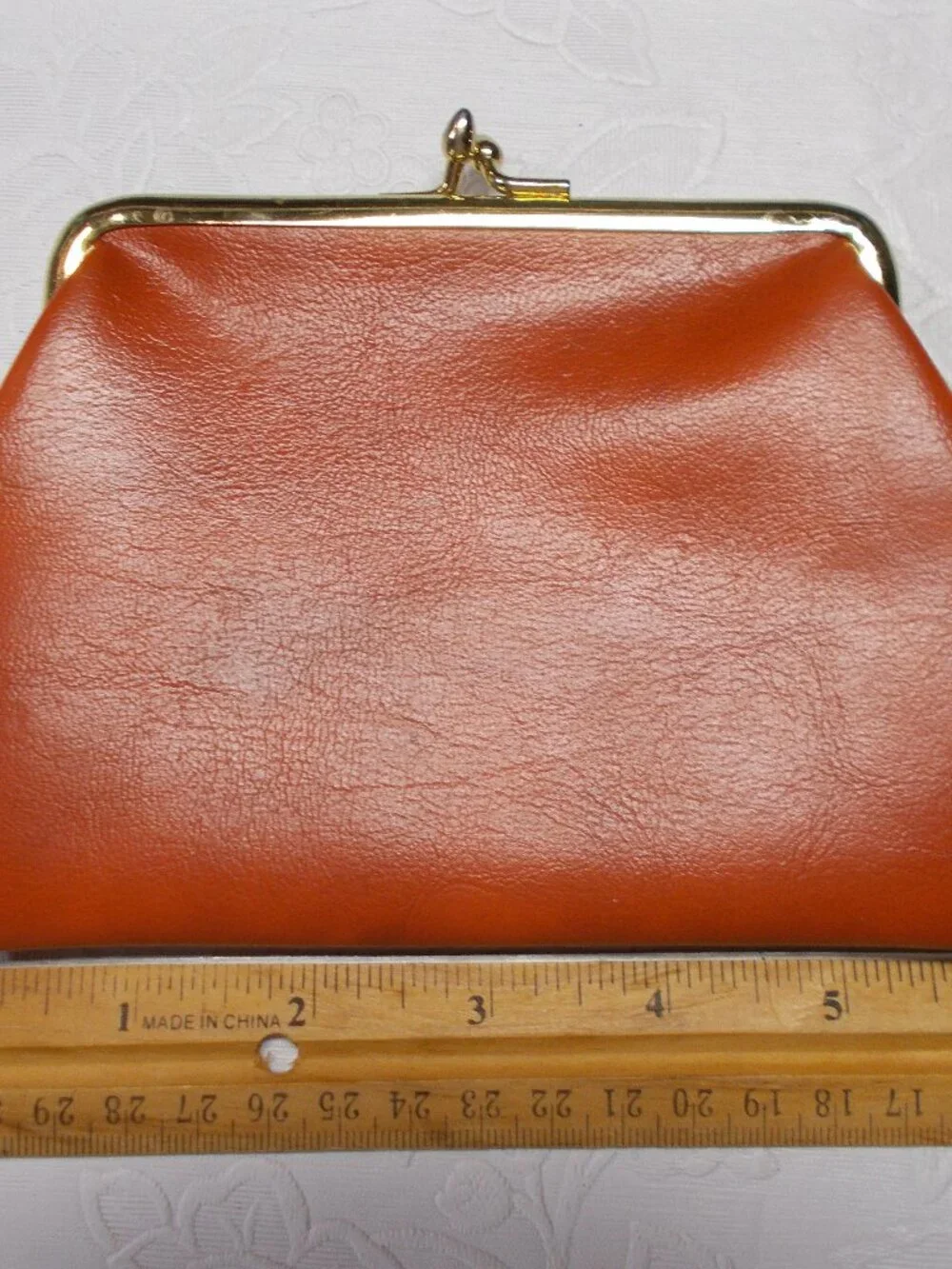Vintage leather orange/rust color coin/wallet/pouch with gold-color snap